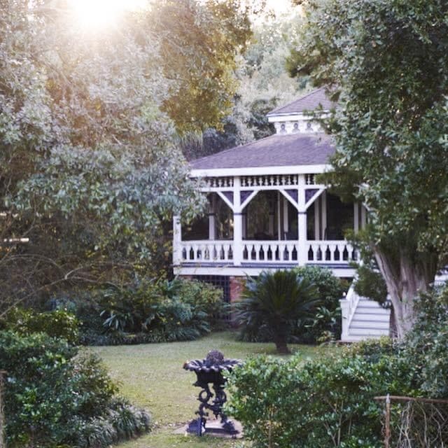 Gardens at Poplar Grove at golden hour, sun filtering through the live oaks.