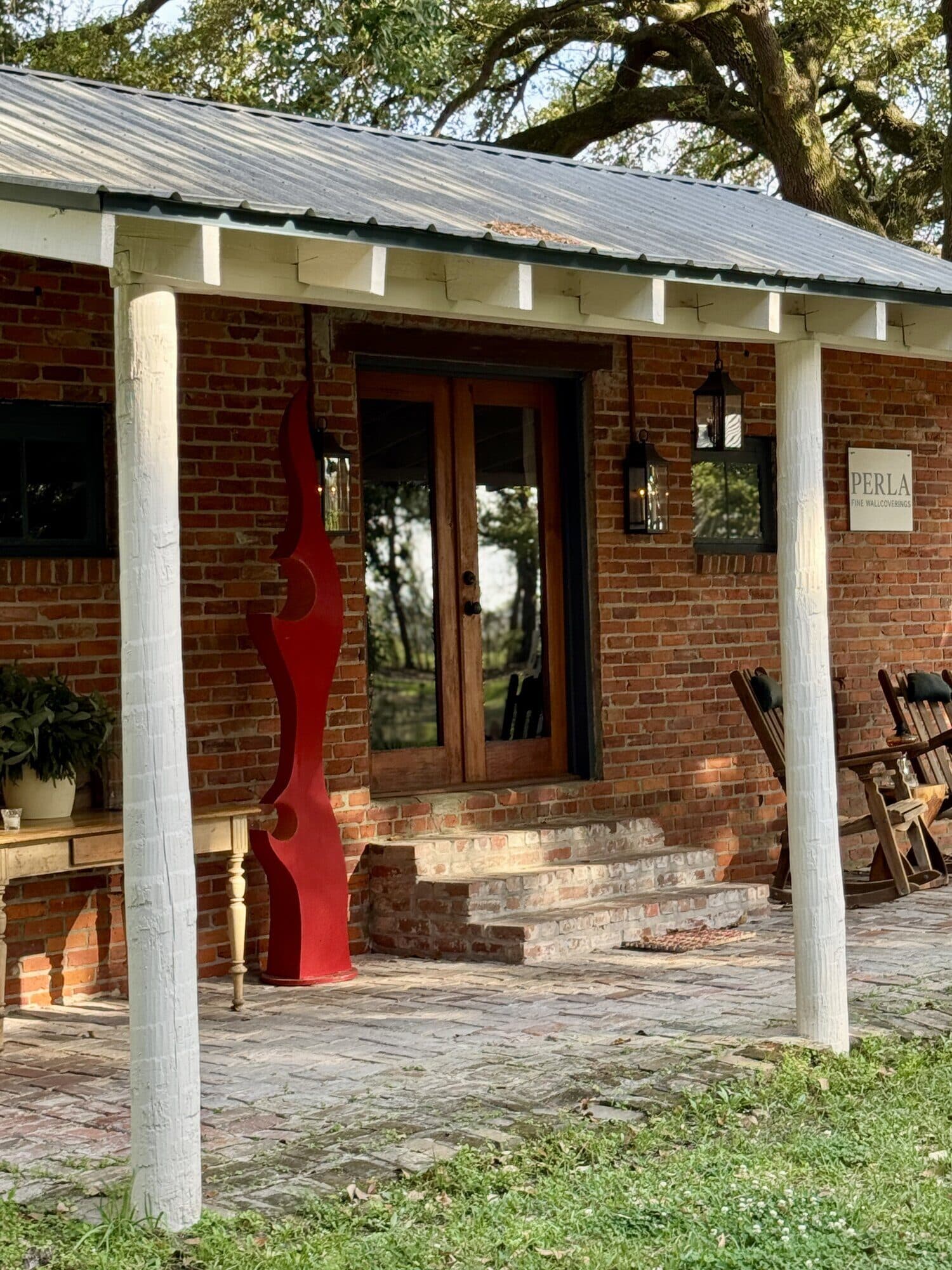 The Perla Fine Wallcoverings showroom — a renovated brick building on the Poplar Grove grounds.