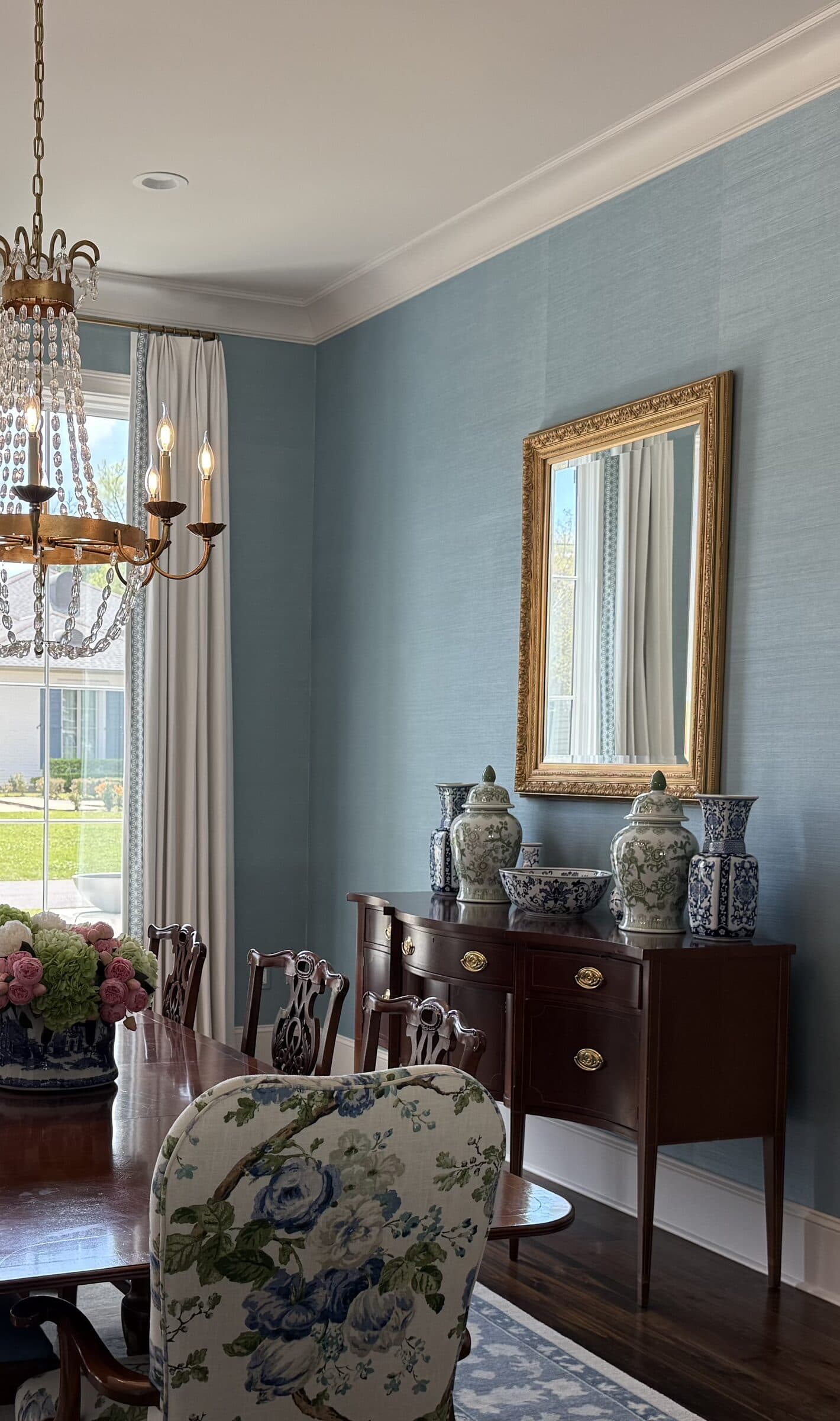 Blue grasscloth wallcovering in a dining room, installed by Perla