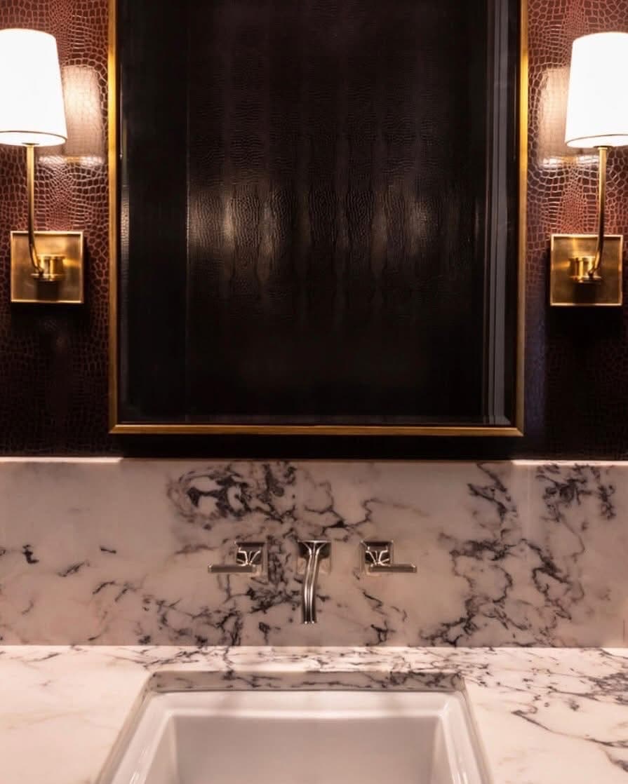 Burgundy crocodile-pattern wallpaper in a powder room, installed by Perla