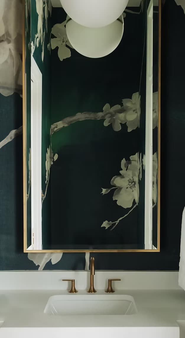 Green floral wallpaper in a powder room, installed by Lauren Buckholtz