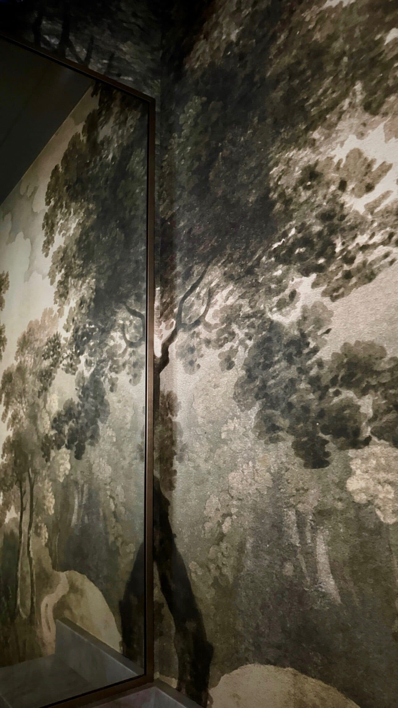 Moody landscape mural installed by Perla in a designer's home